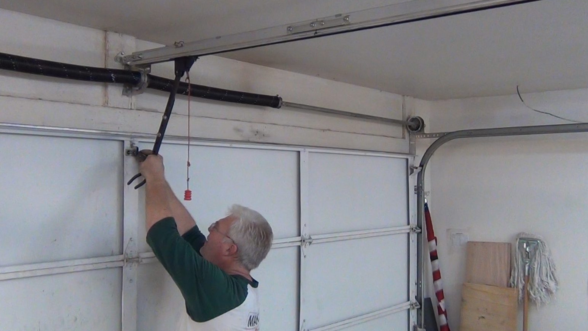 A man adding garage door security for better protection