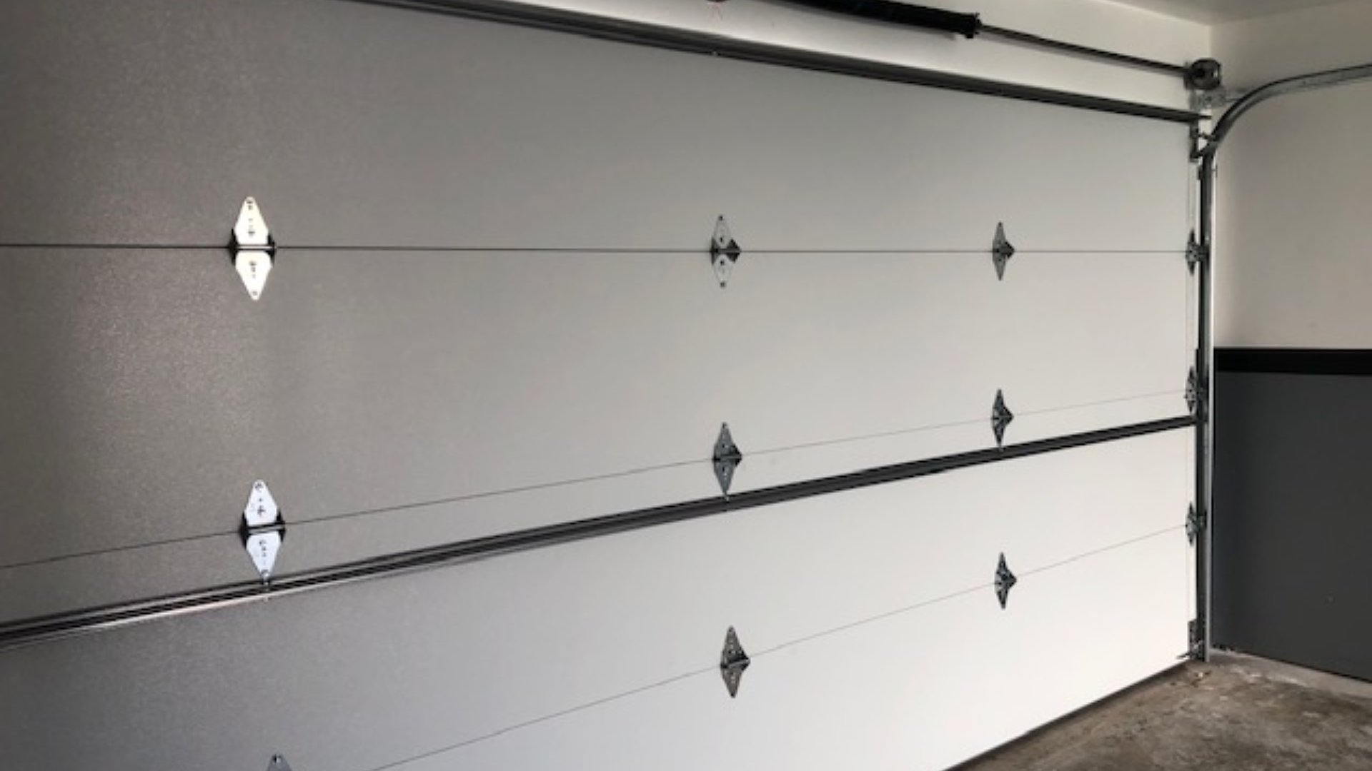 View of a new insulated garage door from inside the garage.