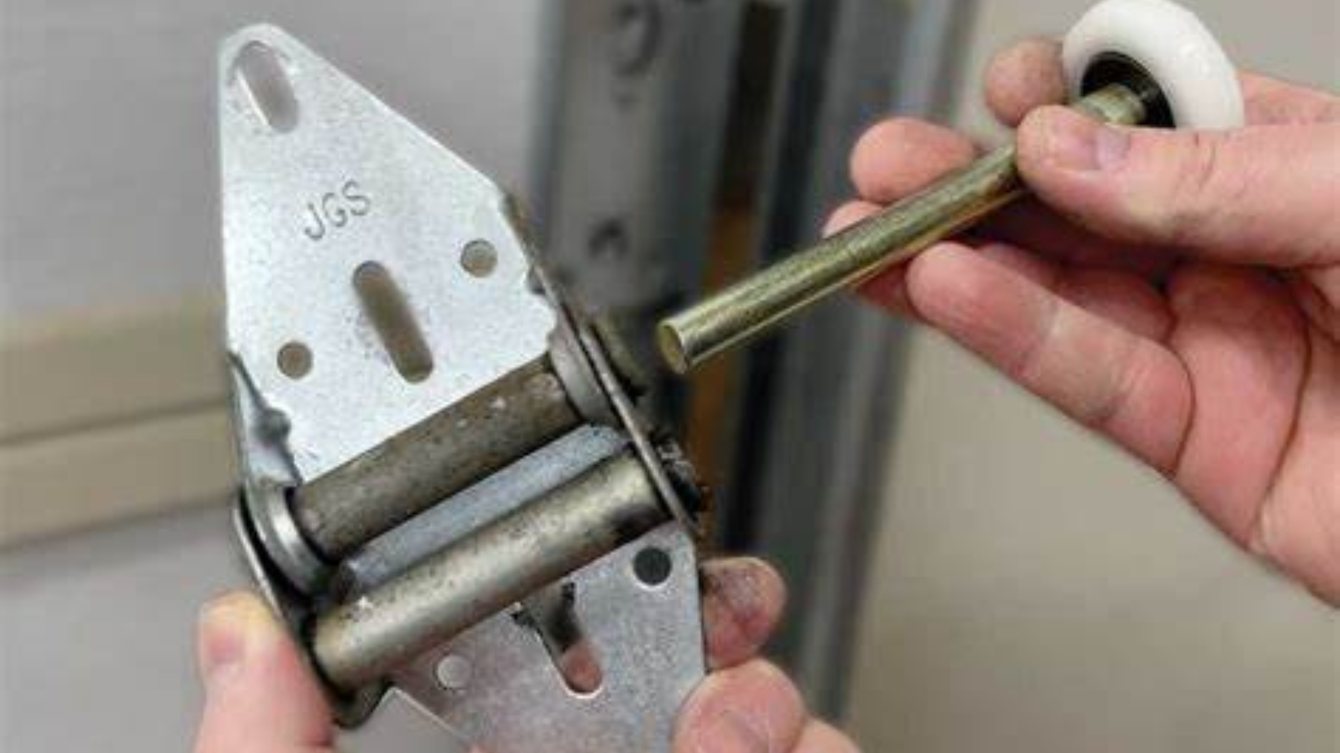 Replacing garage door roller when door won’t open smoothly.